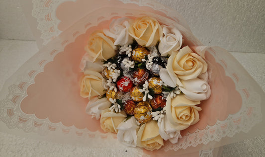 A sweet bouquet of LINDOR sweets  and scented cream roses for  bath